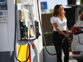 Lower gas prices are somewhat bittersweet given the renewed concerns about the COVID-19 pandemic and new mask and vaccine mandates. (Joe Raedle/Getty Images)