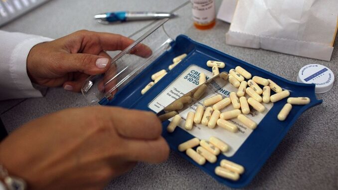 Antibiotics are essential to curing bacterial infections, but their overuse promotes the appearance and proliferation of antibiotic-resistant bacteria. Pictured, a Publix Supermarket pharmacy manager counts out the correct number of antibiotic pills to fill a prescription in Miami, Florida. (Joe Raedle/Getty Images)