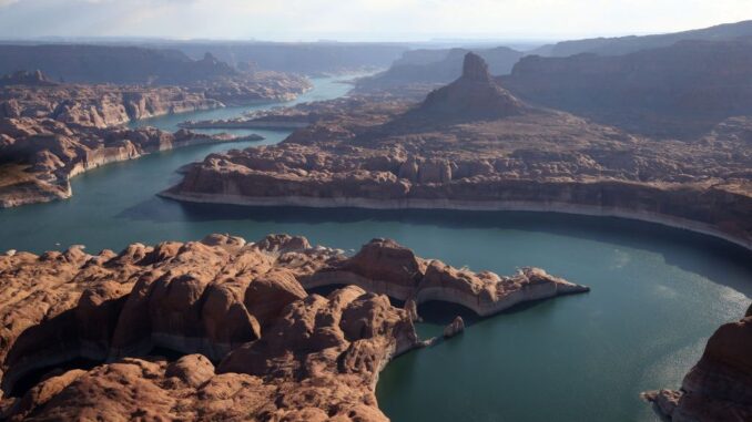 Lake Powell, a critical source of hydropower and water for the West, is continuing to dry up. In this file photo, the tall bleached bathtub ring is visible on the rocky banks of Lake Powell on June 24, 2021 in Lake Powell, Utah.  (Justin Sullivan/Getty Images)