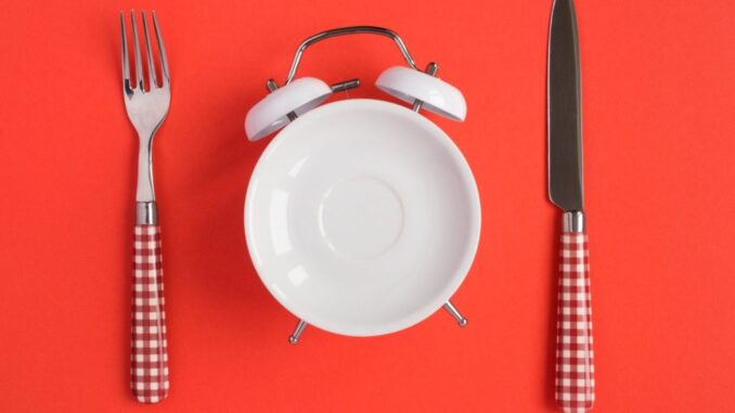 94b12c15-3501-4dbe-9c0c-ba0abe977943 A table set with a fork and a knife including a plate as a clock. Intermittent fasting popular with celebrities is ineffective for shedding weight, according to new research. PEDAL TO THE STOCK/SWNS TALKER